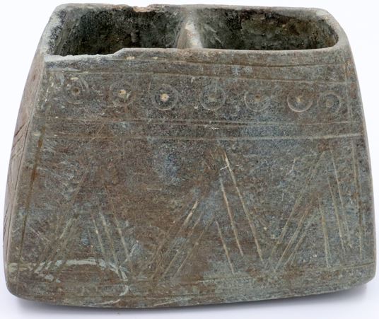 A two compartmented stone vessel