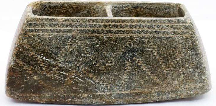 A compartmented stone vessel
